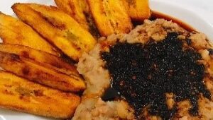 A plate of food with rice and plantains.