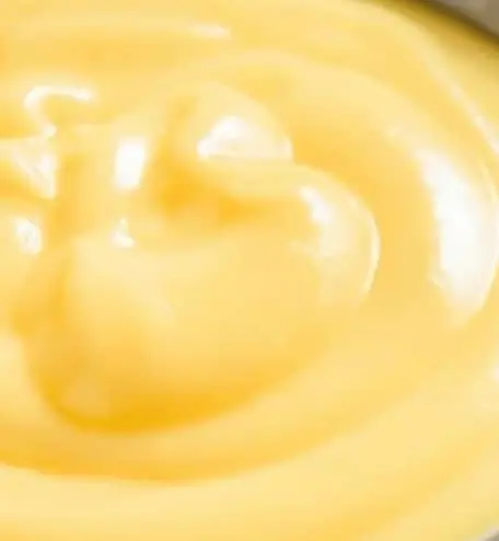 A close up of some yellow liquid in a bowl