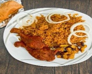 A plate of food with rice, meat and onions.