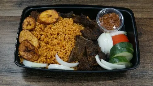 A tray of food with rice, meat and vegetables.